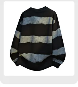Close-up detail of black and grey striped sweatshirt, soft textured fabric and cuffs.