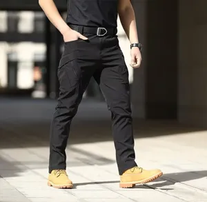 Close-up detail of black tactical cargo pants with multiple functional pockets for outdoor.