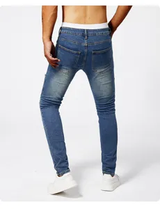 Men slim fit ripped blue jeans detail view, stretch denim casual trousers for daily wear.