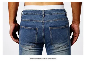 Men slim fit stretch denim jeans detail view showcasing back pockets and blue wash.