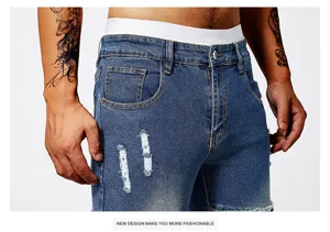 Close-up view of men's blue denim ripped jeans showing detailed stitching and distressed knees.
