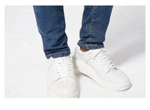 Detail shot of men's slim fit stretch blue denim jeans paired with casual white sneakers.