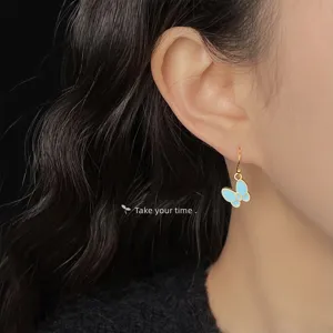 Mint green enamel butterfly earrings for women, sweet and elegant fashion jewelry for summer.