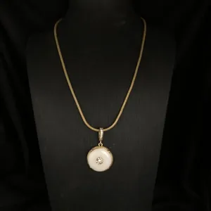Vintage retro style gold-toned snake chain necklace with white stone pendant and rhinestones