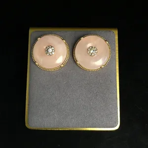 Vintage pink stone peace buckle earrings with rhinestone inlay gold tone retro style jewelry.