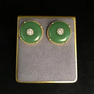 Vintage green safety buckle earrings detailed close-up shot, elegant rhinestone decor.