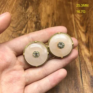 Detailed close-up of vintage style round rhinestone embellished jewelry piece, exquisite texture.