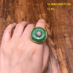Vintage style green peace buckle ring with sparkling rhinestones and elegant gold tone setting.