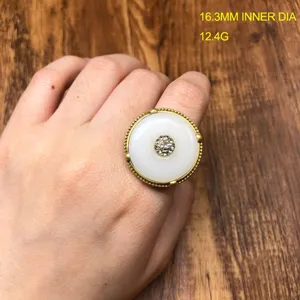 Detailed close-up view of vintage safety buckle ring featuring white stone and sparkling rhinestones.