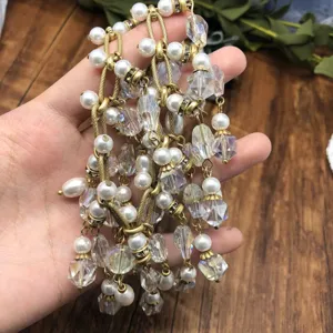 Detailed view of vintage multi-strand tassel necklace with pearls and crystal beads.