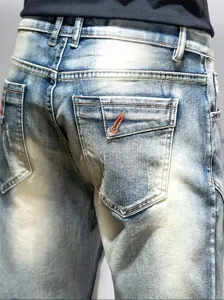 Men's light blue distressed denim shorts detail view, featuring back pockets and slim fit style.