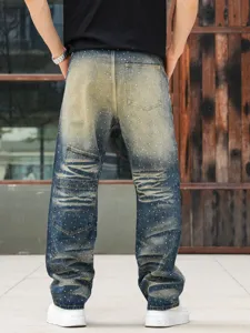 Men's loose straight fit denim jeans with heavy wash vintage yellow mud and rhinestone details.