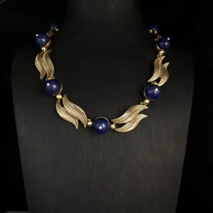 Vintage blue stone and gold leaf statement necklace, elegant retro design jewelry for women.
