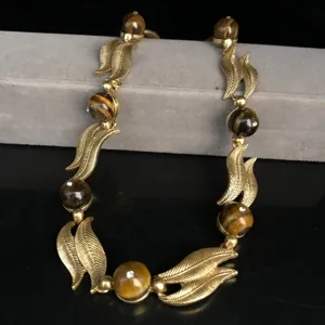 Vintage gold leaf tiger eye stone beaded necklace detail closeup shot elegant jewelry accessory