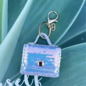 Detailed macro view of an iridescent blue sequin mini earphone bag keychain pendant