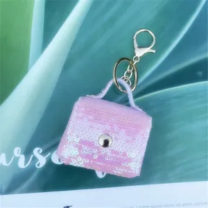 Detailed macro shot of a pink gradient sequin miniature bag keychain used as a coin purse