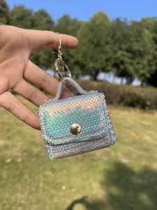 Close-up of mini sequin coin purse keychain in outdoor sunlight