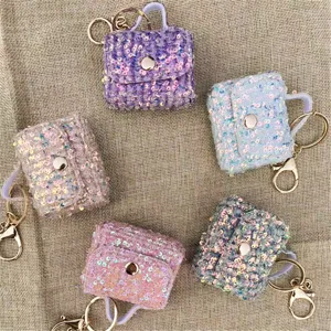 Top view showing five colorful sequined mini bag keychains and pouches in pastel tones