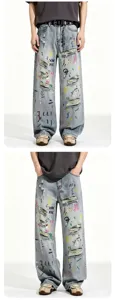 Loose fit straight blue washed denim jeans with distressed rips and colorful graffiti print for men.