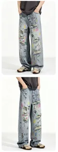 Detailed view of loose fit light blue distressed denim jeans with colorful graffiti prints.