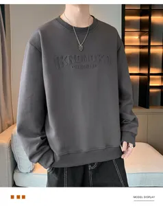 Men's heavyweight crewneck sweatshirt detail in dark grey featuring stylish embossed chest text.