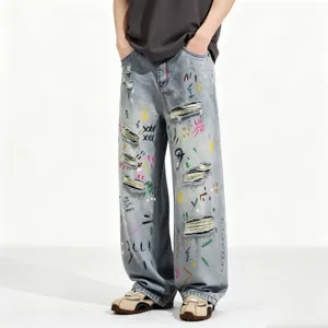 Men's loose fit straight leg light blue washed distressed denim jeans with colorful graffiti.