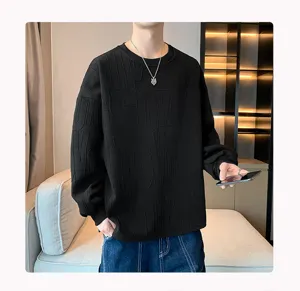 Detailed view of men's black crewneck sweatshirt with stylish embossed text pattern.
