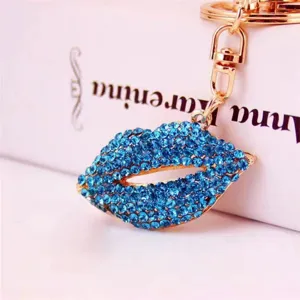 Close-up detail of a sparkling blue rhinestone lips keychain with shiny gold hardware pendant.
