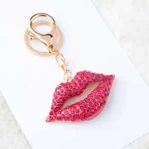 Detailed view of the sparkling red crystal lips keychain, stylish gold-tone metal hardware.