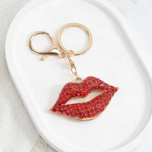 Red crystal lips keychain detail, stylish metal bag charm and car key accessory gift.
