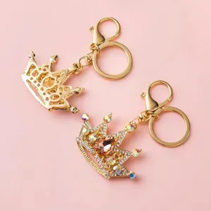 Rhinestone crown keychain detail shot, gold metal finish, sparkling crystal accents for bags.