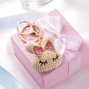 Cute pearl bunny rabbit keychain with pink rhinestone bow bag charm jewelry accessory detail view.
