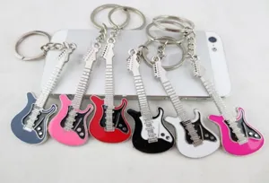 Detailed close-up view of assorted colorful metal guitar keychains on white surface.
