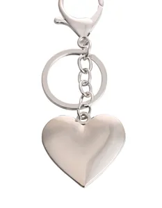 Silver metal heart keychain detail, polished finish pendant with clasp and rings.