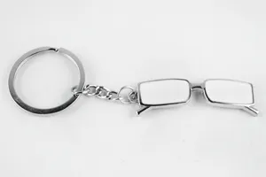 Metal creative glasses keychain pendant, stylish silver tone finish with white enamel detail.