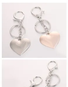 Metal heart keychain detail view, showing the exquisite polished surface and chain.