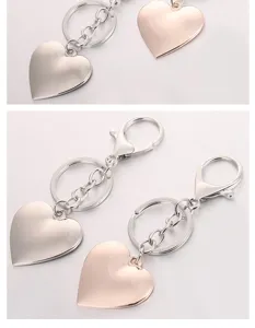 Close-up detail of metal heart keychains with lobster clasp and shiny finish.