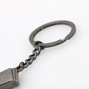 Close-up detail shot of a sleek gun black metal key ring and chain, durable hardware accessory.