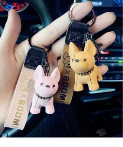 Cute French bulldog keychain detail shot, cartoon puppy bag charm accessory with strap.