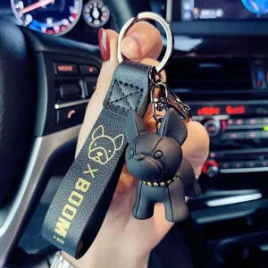 Cute French Bulldog keychain with black leather strap and metal ring for car keys and bags.