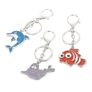 Cute marine animal metal keychains featuring dolphin, seal and clownfish designs.