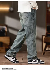 Detail shot of men vintage washed denim jeans showing side seam and relaxed straight fit style.