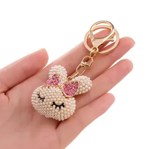Cute pearl rabbit keychain with pink crystal bow, stylish metal bag charm for women gifts.