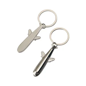 Metal airplane keychain detail shot, showing double-sided design and sturdy keyring.