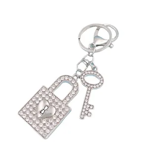 Detail view of sparkly rhinestone heart padlock and key keychain charm for bags and car.