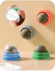 Gros plan détaillé de la balle d'herbe à chat rotative avec base adhésive pour mur.