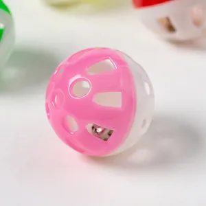 Plastic hollow cat toy ball with built-in bell, pink and white interactive pet toy for kitten fun.