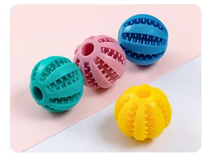 Close-up detail of colorful silicone pet chew toys, teeth cleaning balls with food leaking holes.