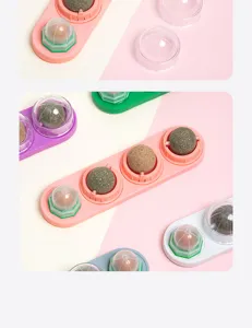 Catnip wall toy detail showing colorful cat grass balls and protective clear covers.