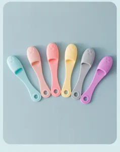 Detailed close-up of colorful silicone face washing brushes in various pastel shades.
